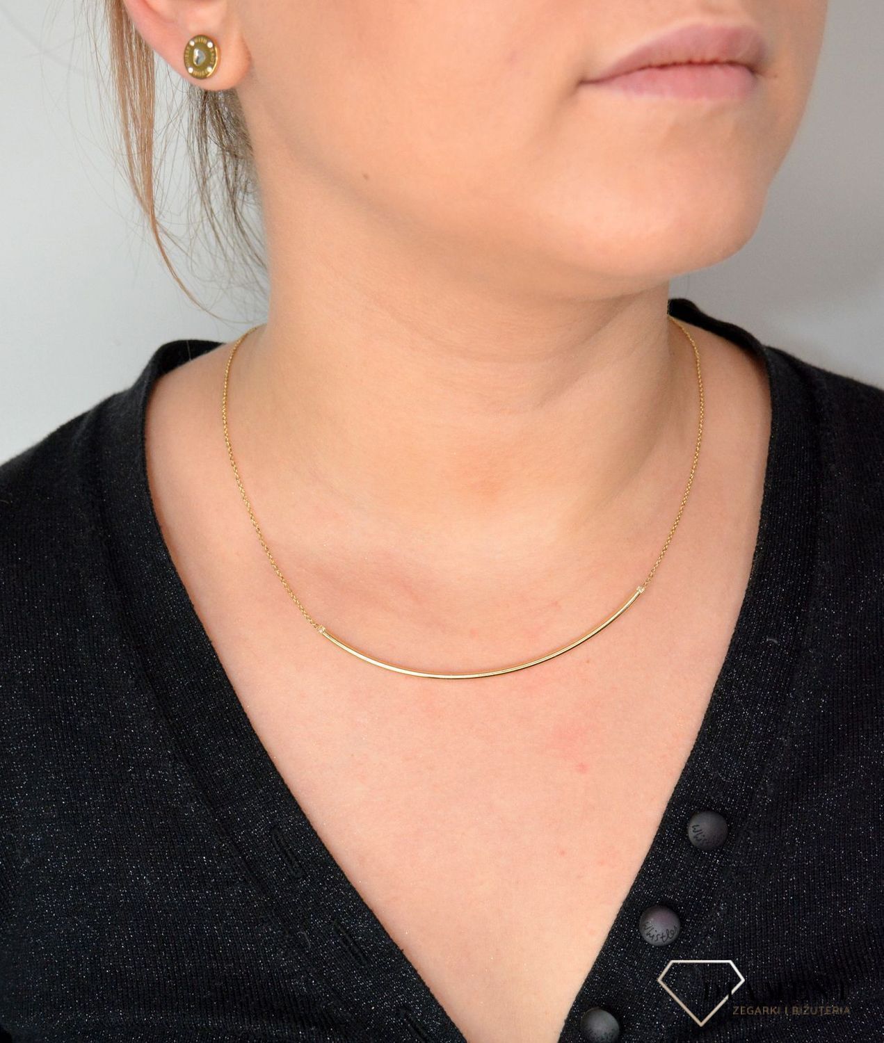 Złoty naszyjnik ze sztywną ozdobą zakończony cyrkonią NA 2971.jpg